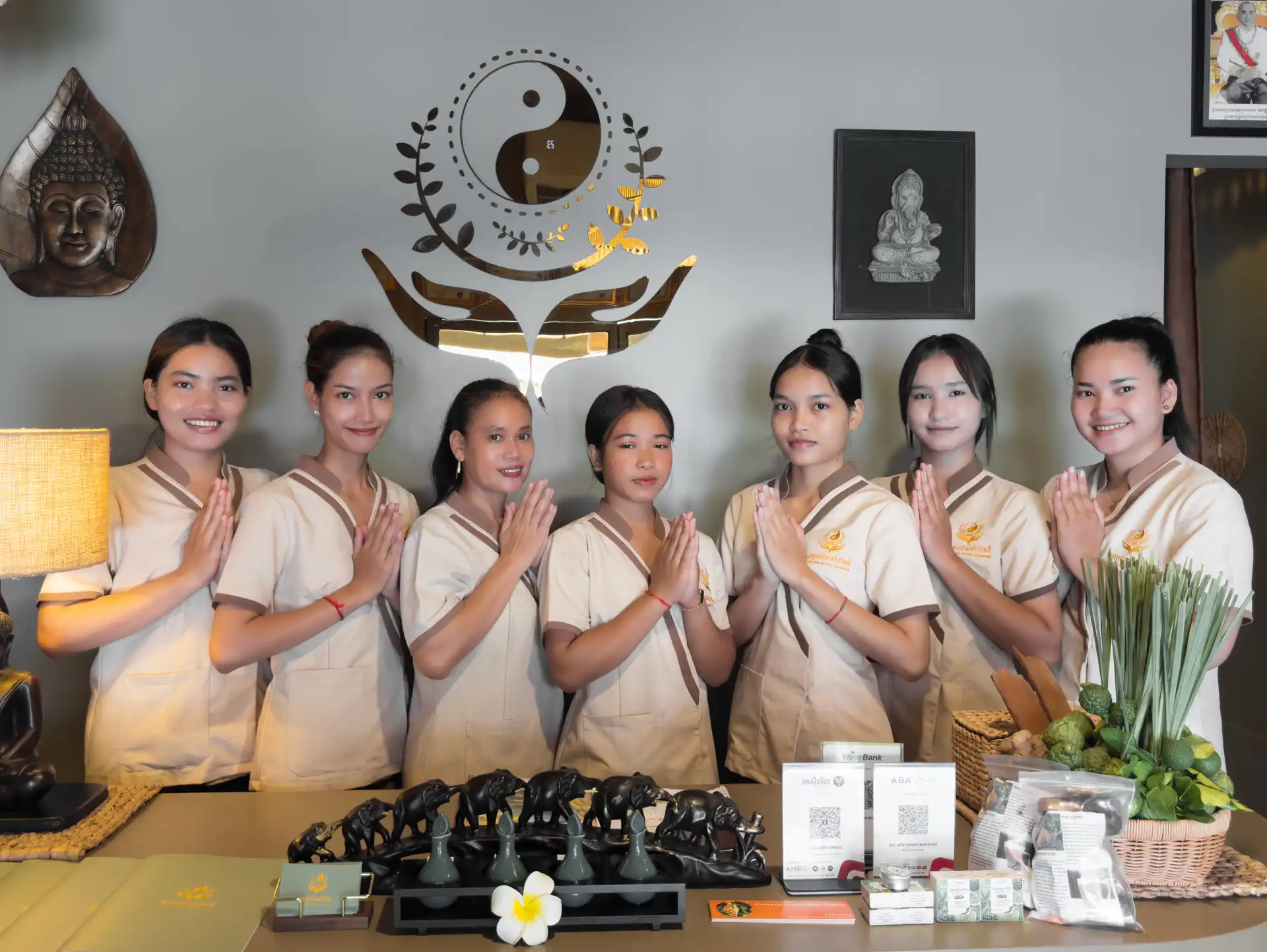 The Golden Hands team greeting guests with a traditional sampeah at the reception desk