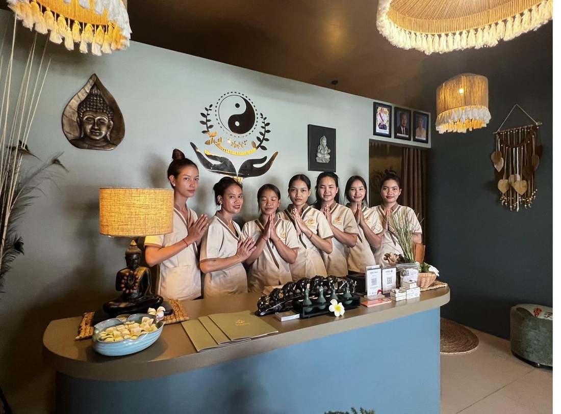 The Golden Hands team greeting guests with a traditional sampeah at the reception desk